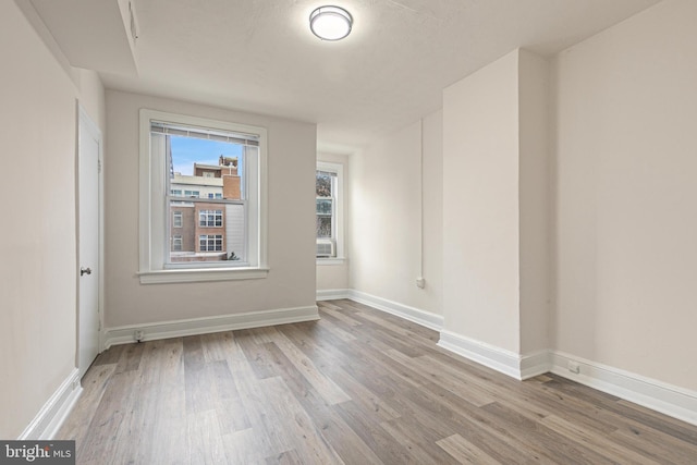 unfurnished room featuring light hardwood / wood-style floors