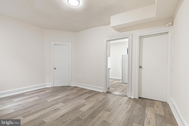 unfurnished room with light hardwood / wood-style flooring