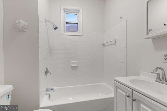 full bathroom with vanity, toilet, and tiled shower / bath