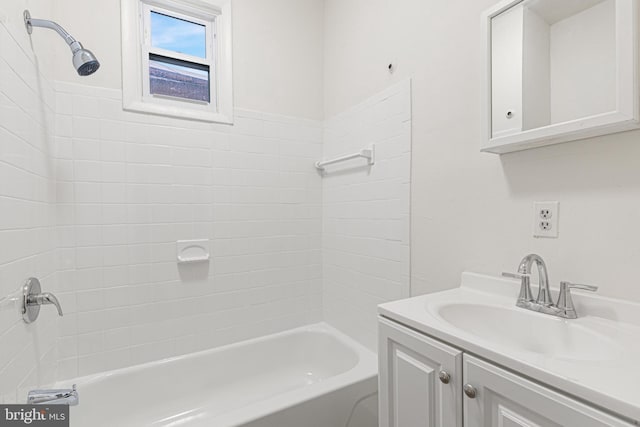 bathroom with vanity and tiled shower / bath combo