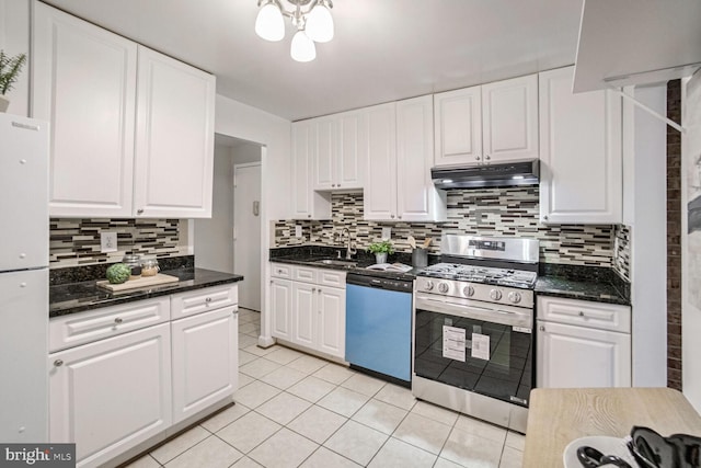 kitchen featuring sink, stainless steel appliances, light tile patterned floors, decorative backsplash, and white cabinets