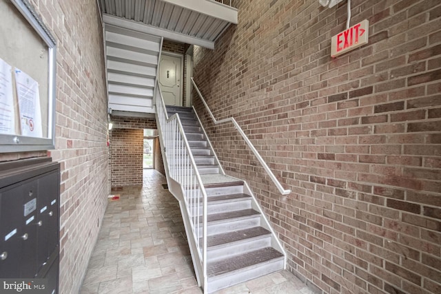 staircase with brick wall