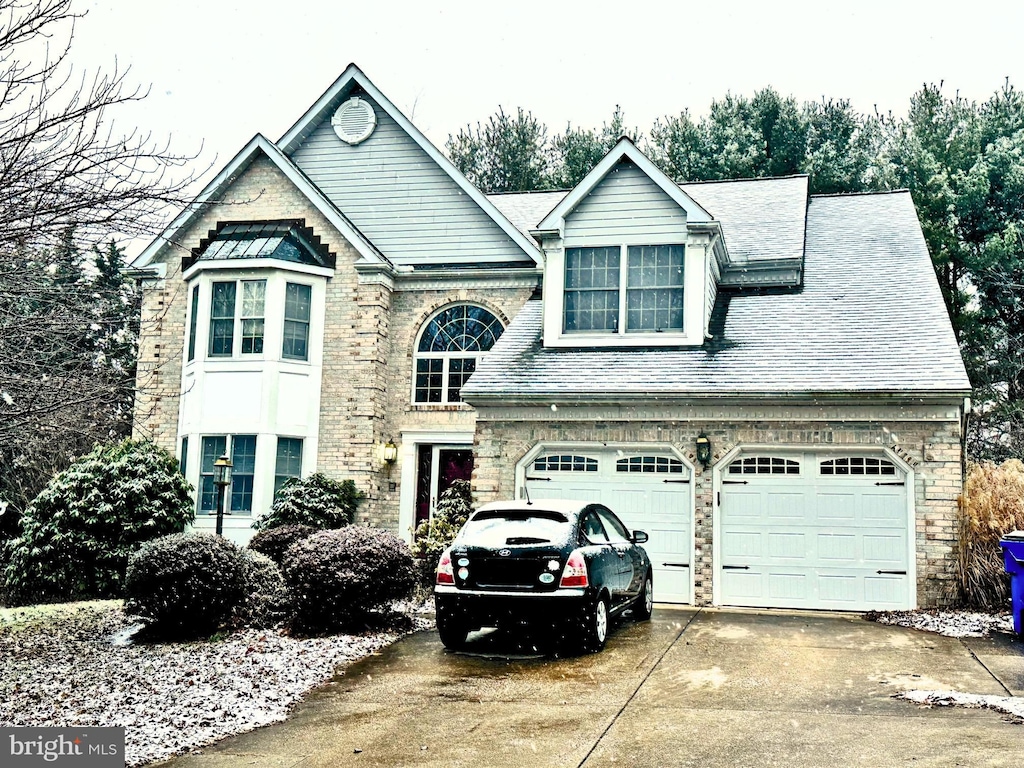 view of front of home featuring a shingled roof and driveway