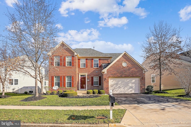 view of front of property with a front lawn and a garage