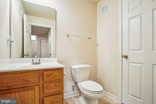 bathroom featuring tile patterned floors, vanity, and toilet