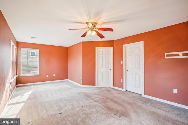 unfurnished bedroom featuring ceiling fan and light colored carpet