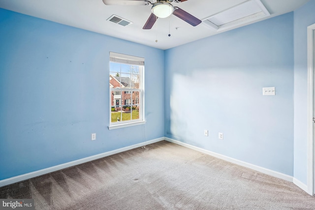 carpeted spare room featuring ceiling fan