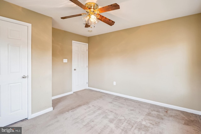 unfurnished room with ceiling fan and light carpet