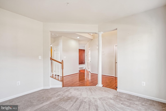 empty room with carpet flooring and ornate columns