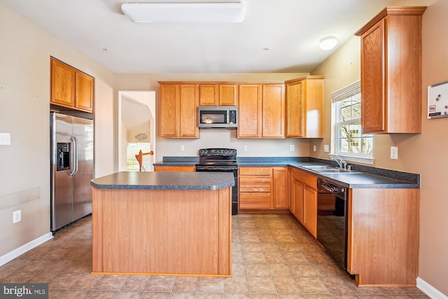 kitchen with black appliances, a center island, and sink