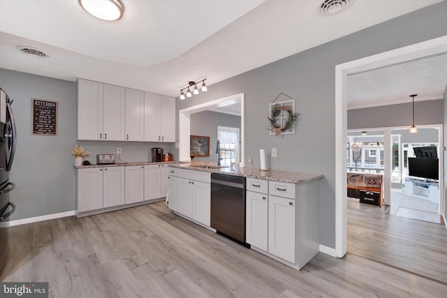 kitchen featuring white cabinets, light wood-type flooring, black dishwasher, and sink