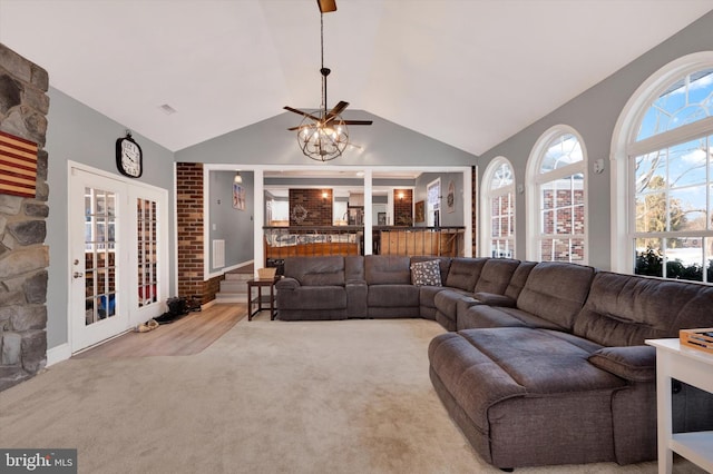 carpeted living room featuring lofted ceiling and french doors