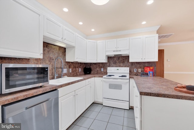 kitchen with white cabinets, light tile patterned floors, stainless steel appliances, and sink