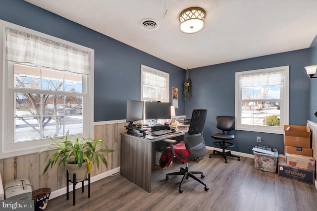 office space featuring plenty of natural light and hardwood / wood-style flooring