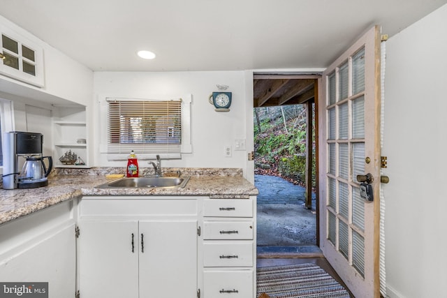 kitchen featuring white cabinets, dark carpet, a healthy amount of sunlight, and sink