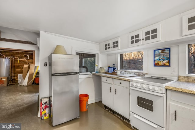 kitchen featuring white cabinets, stainless steel fridge, stove, and water heater