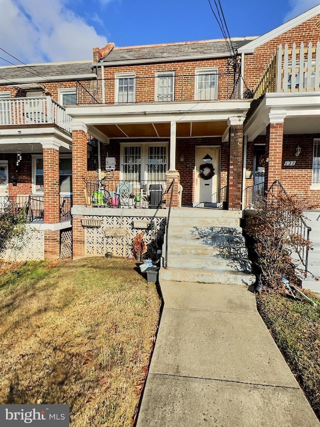 view of property with a porch and a front yard