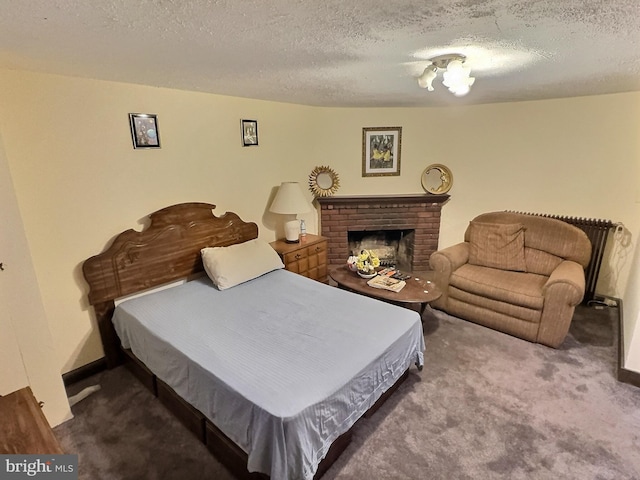 carpeted bedroom featuring a textured ceiling and a brick fireplace