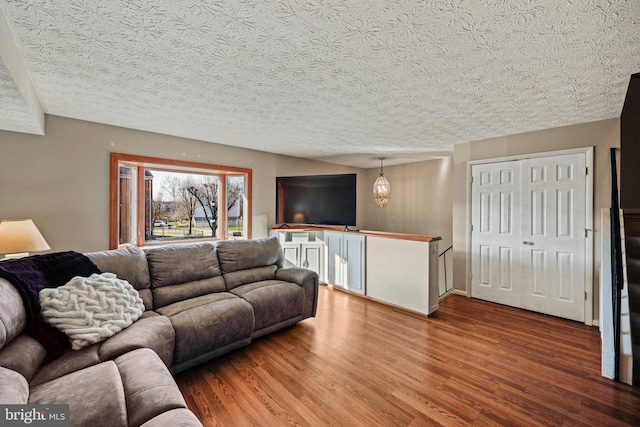 living room featuring a textured ceiling and hardwood / wood-style flooring