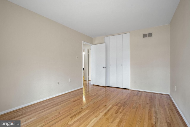 unfurnished bedroom featuring a closet and light hardwood / wood-style flooring