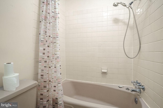 bathroom with shower / tub combo and toilet