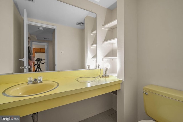 bathroom featuring sink, tile patterned floors, and toilet