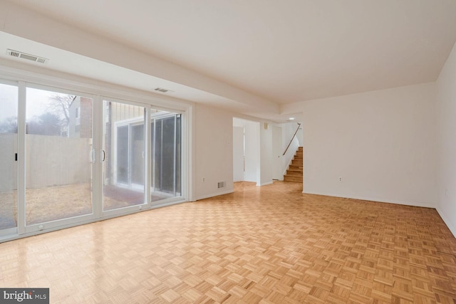 unfurnished living room with light parquet flooring