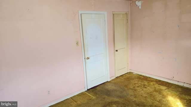 empty room with dark colored carpet