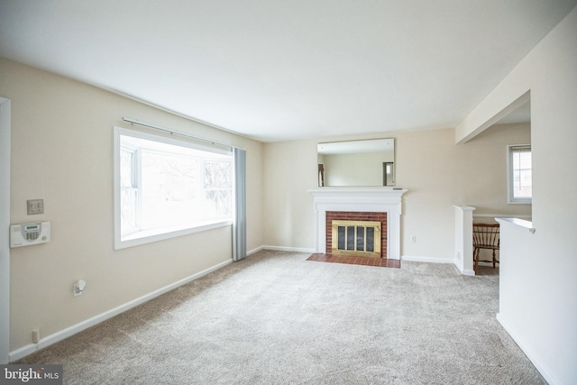 unfurnished living room featuring light carpet and a brick fireplace