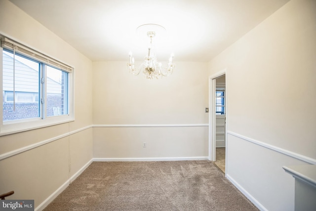 unfurnished room with light colored carpet and a notable chandelier