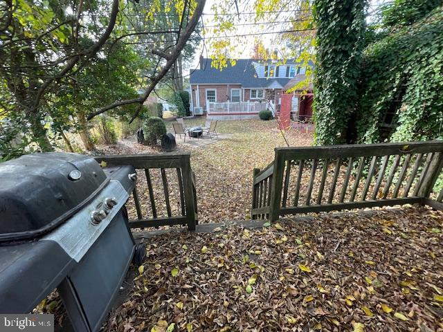 view of yard featuring a wooden deck and an outdoor fire pit