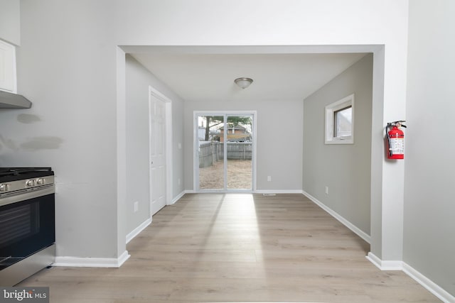 unfurnished dining area featuring light hardwood / wood-style flooring