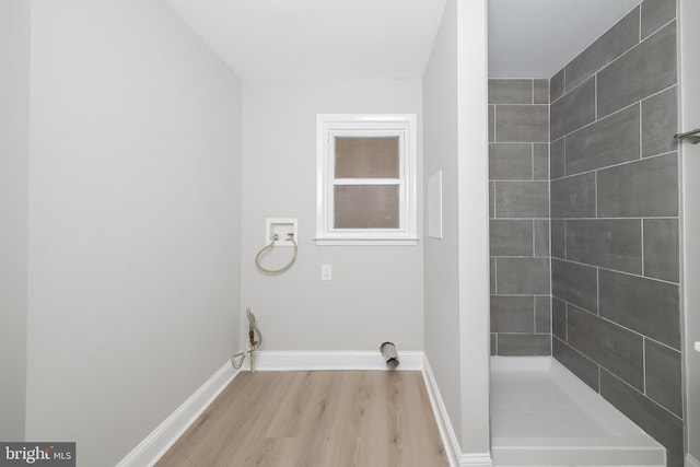 laundry room featuring hookup for an electric dryer, washer hookup, and light hardwood / wood-style floors