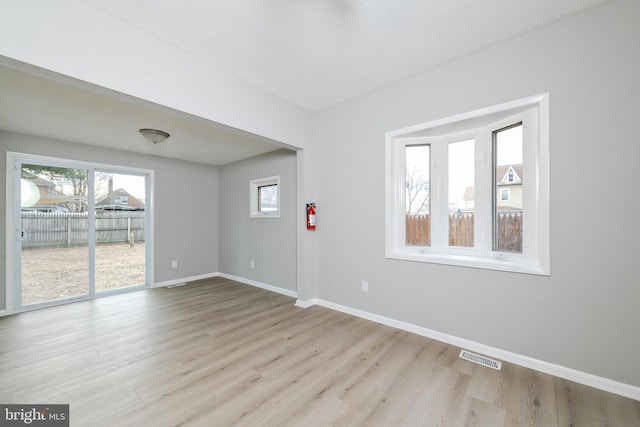 unfurnished room with light hardwood / wood-style flooring