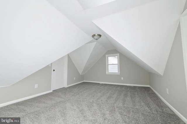 bonus room with carpet flooring and lofted ceiling