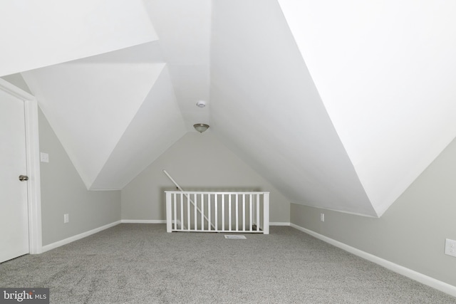 additional living space featuring carpet floors and lofted ceiling