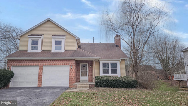 view of front of property featuring a garage and a front lawn