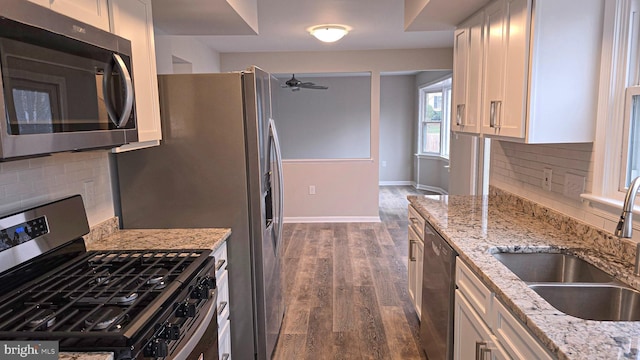 kitchen featuring backsplash, white cabinetry, sink, and stainless steel appliances