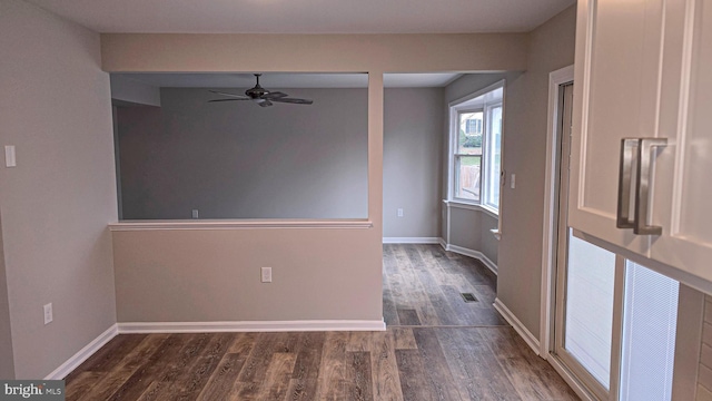 unfurnished room with dark hardwood / wood-style floors and ceiling fan