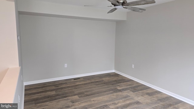 spare room featuring dark hardwood / wood-style flooring and ceiling fan