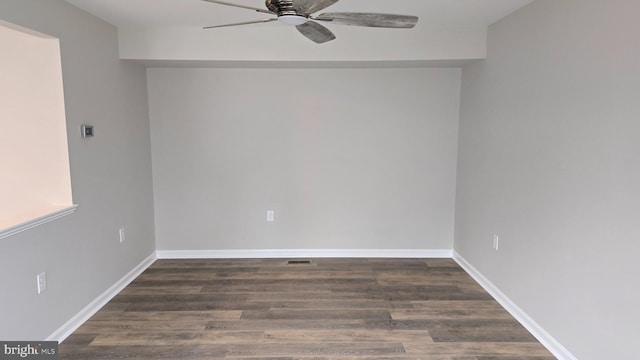 unfurnished room with dark hardwood / wood-style floors and ceiling fan