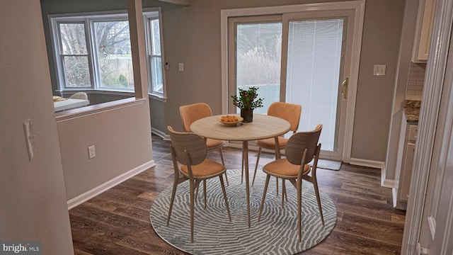 dining space with dark wood-type flooring