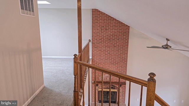 corridor featuring carpet and vaulted ceiling