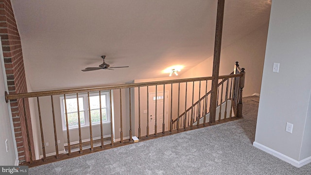 corridor featuring carpet flooring and vaulted ceiling