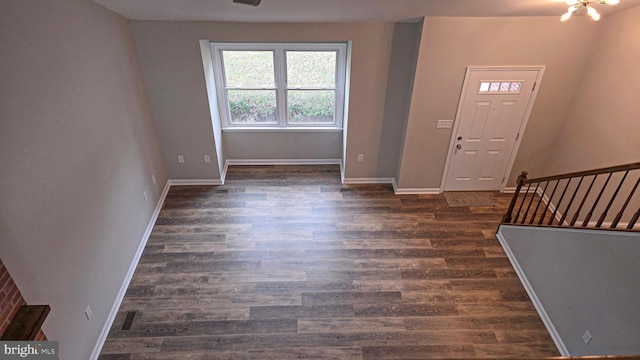 entrance foyer featuring dark hardwood / wood-style floors and an inviting chandelier