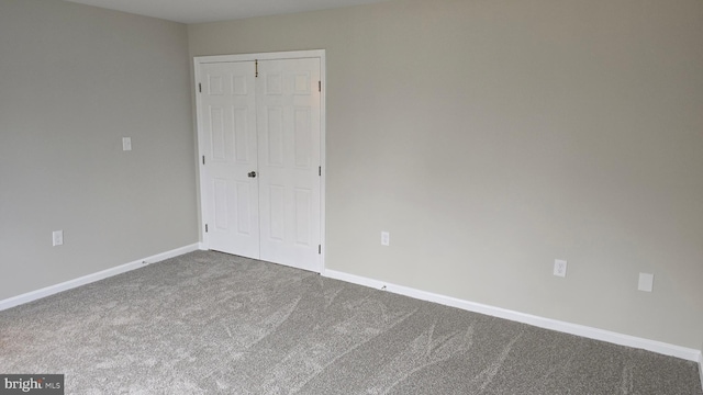 unfurnished bedroom featuring a closet and carpet floors