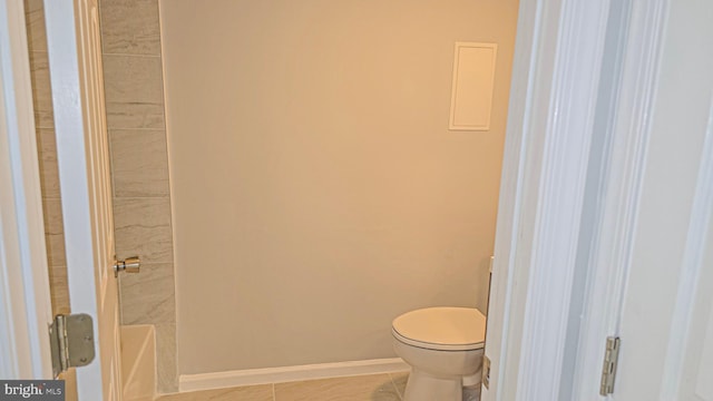 bathroom with tile patterned flooring and toilet