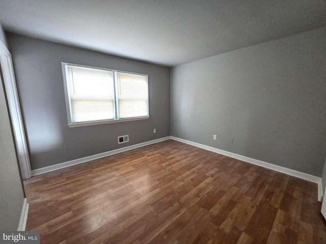 empty room featuring dark hardwood / wood-style flooring