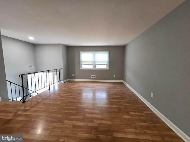 spare room featuring dark wood-type flooring