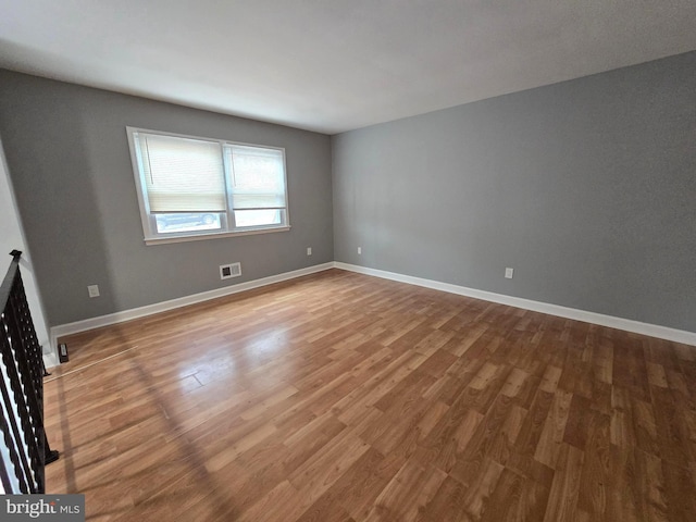 unfurnished room with wood-type flooring